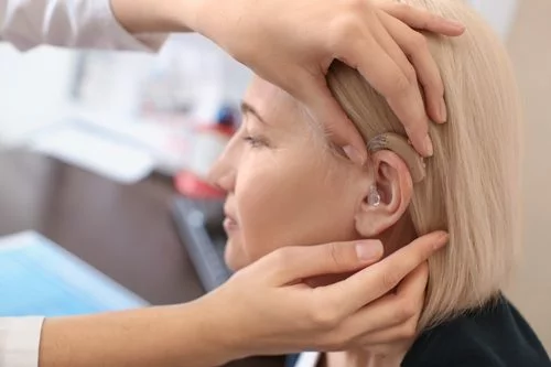 Adjust the position of the hearing aid