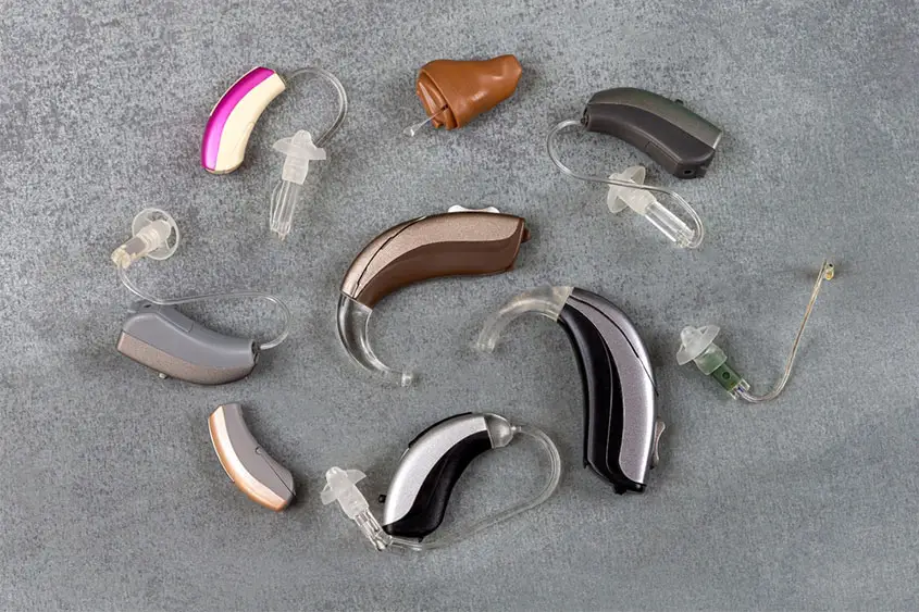 There are many different hearing AIDS placed on the ground